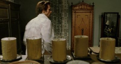 a man standing in front of a table filled with cakes