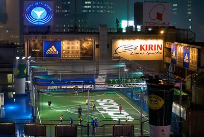 a sports field in a city at night