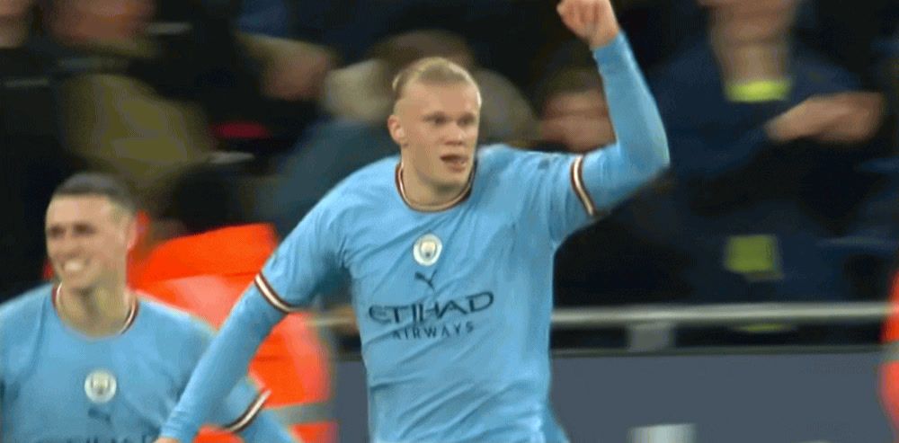 a man in a blue uniform holding a soccer ball