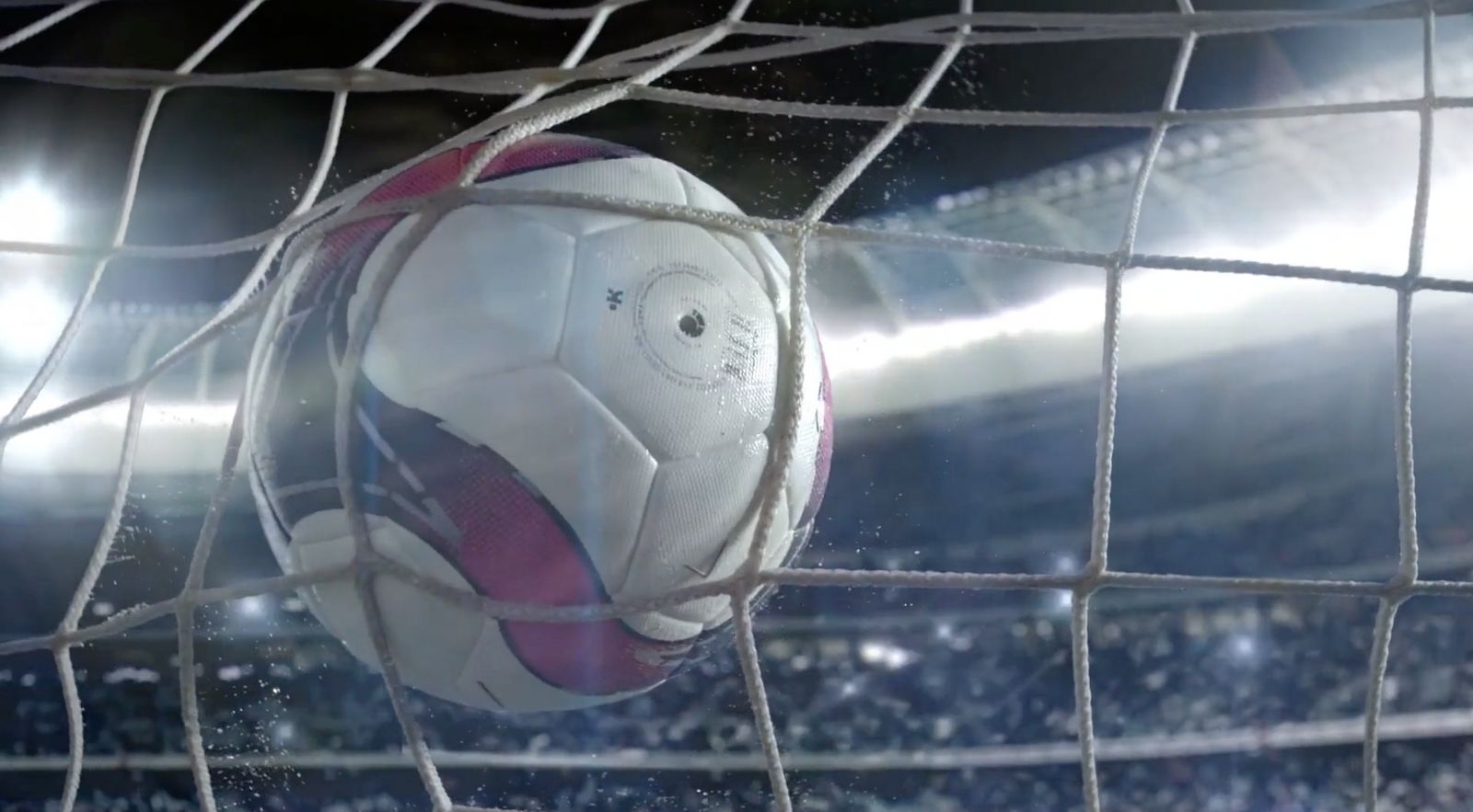 a soccer ball sitting in the net of a soccer field