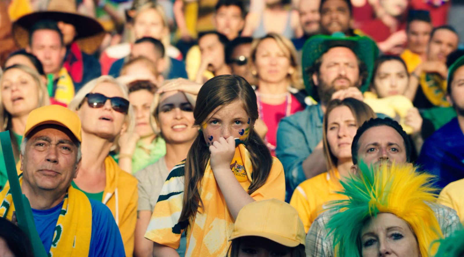 a large group of people wearing yellow and green hats