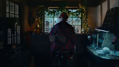 a man sitting at a desk in a dark room