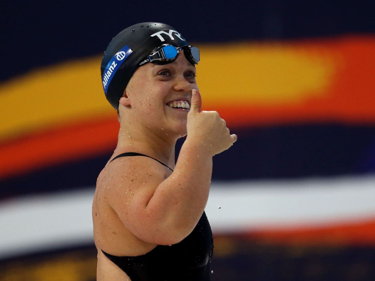 a woman wearing a swimming cap and goggles