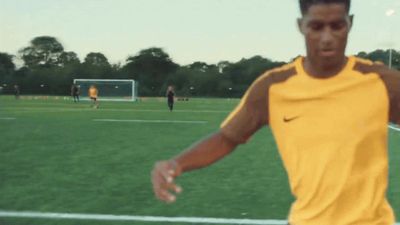 a man in a yellow shirt on a soccer field