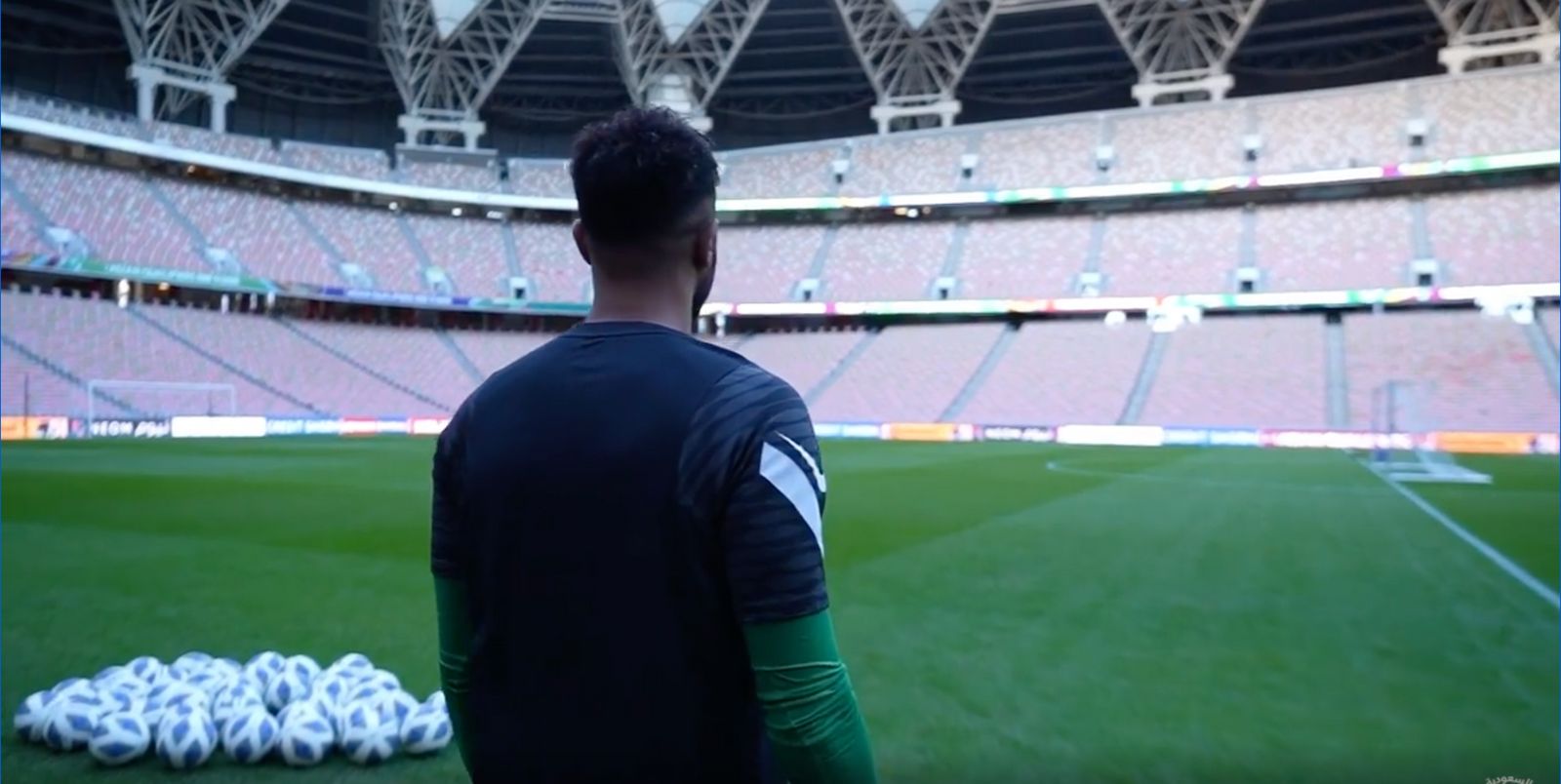 a man standing in front of a soccer field