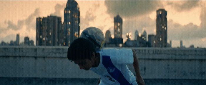 a man riding a skateboard on top of a cement wall