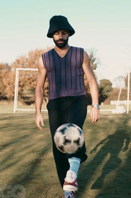 a man is kicking a soccer ball on a field