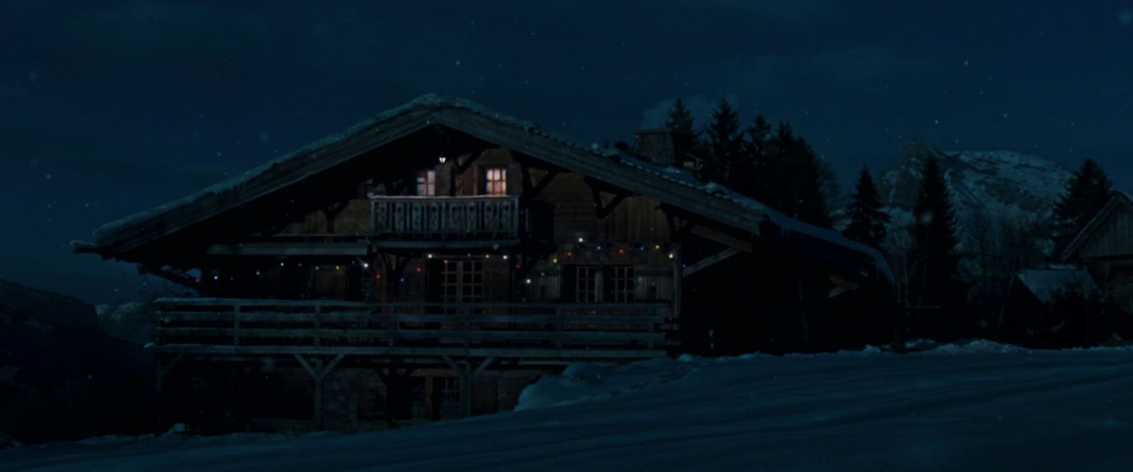 a cabin at night with a full moon in the sky