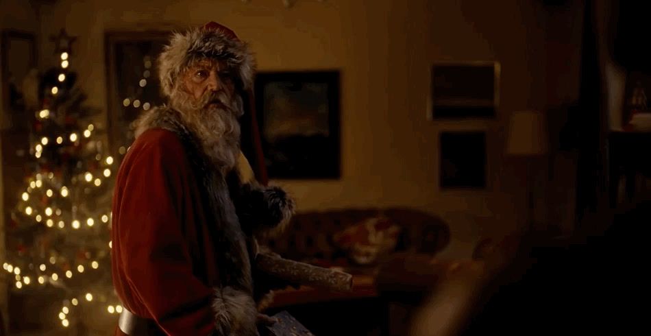 a man dressed as santa claus in a living room