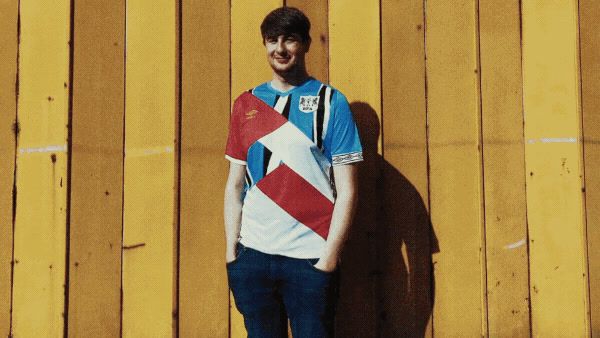 a man standing in front of a yellow wall