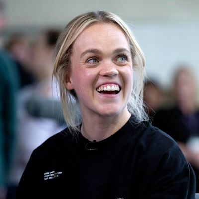 a woman with blonde hair smiling at the camera