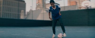 a woman is playing soccer on a court