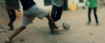 a group of young men kicking around a soccer ball