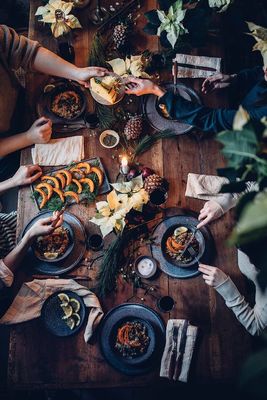 a group of people sitting around a table eating food