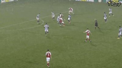 a group of men playing a game of soccer