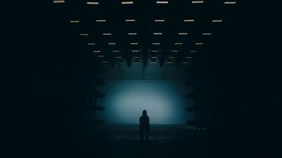 a person standing alone in a dark room