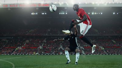 a soccer player jumping up to head the ball