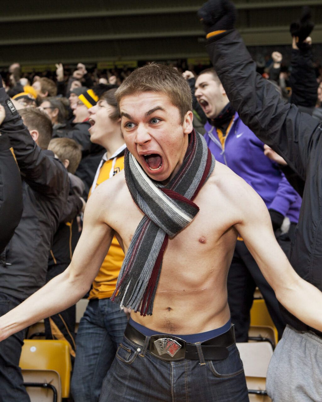 a shirtless man with a scarf around his neck