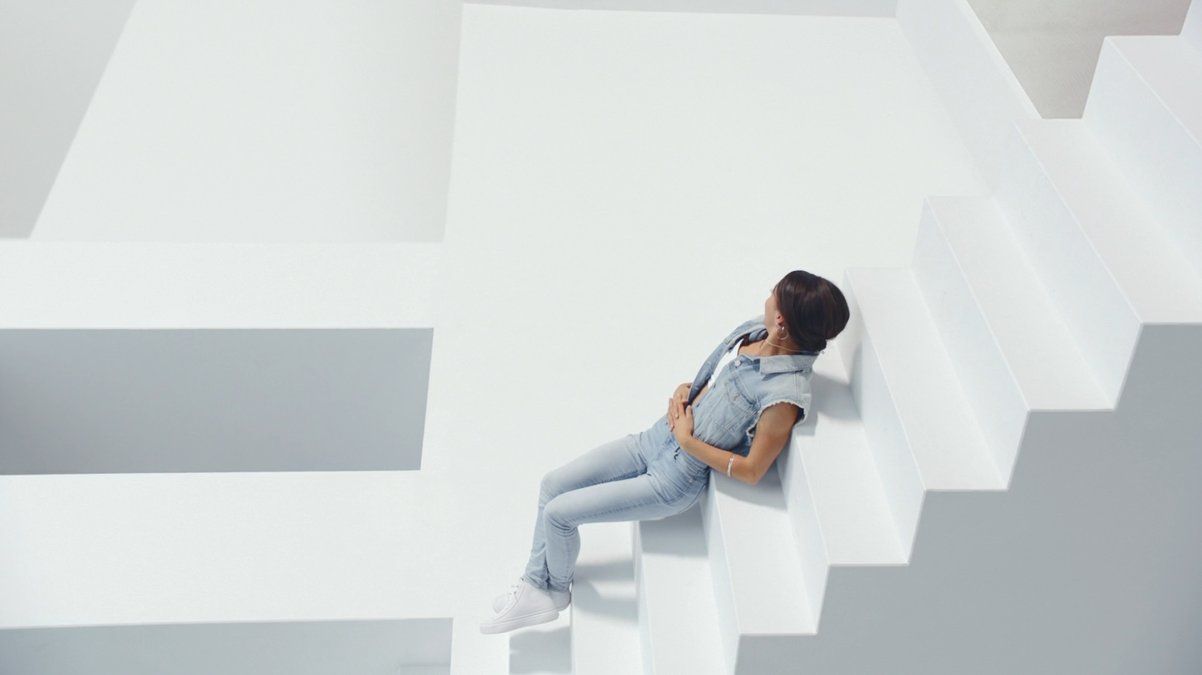 a woman is sitting on a stair case