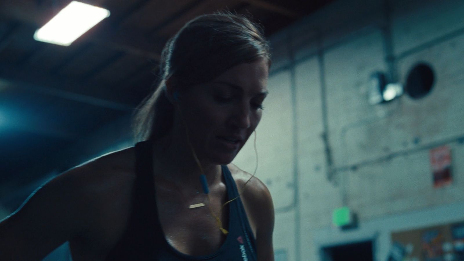 a woman in a gym looking at her cell phone