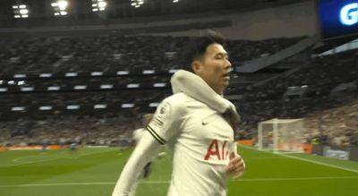 a man in a white uniform running on a soccer field