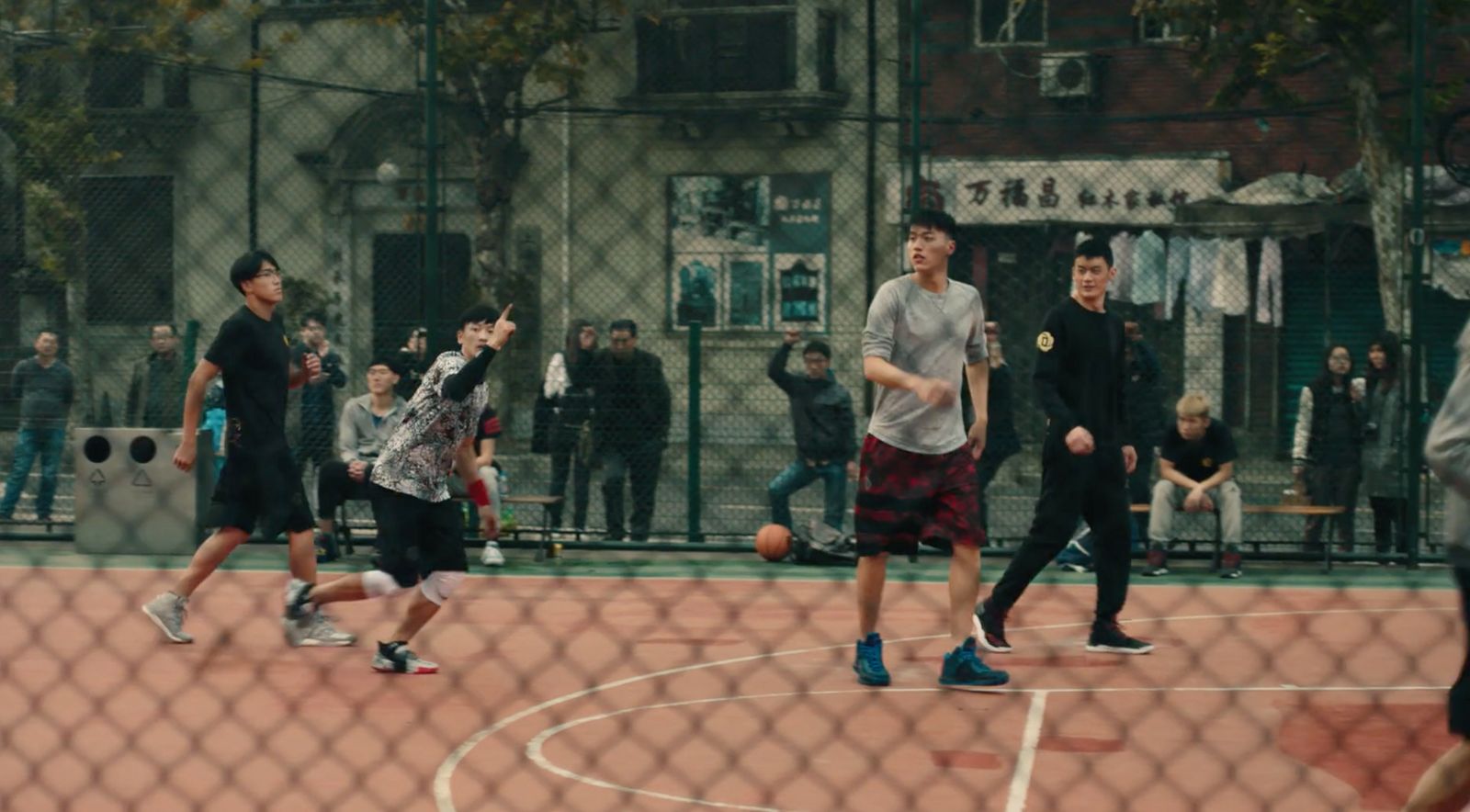 a group of young men playing a game of basketball