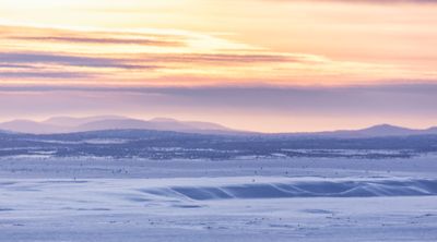 a person walking across a snow covered field