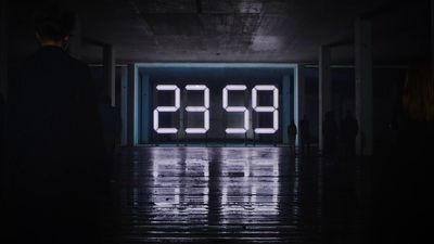 a large digital clock sitting inside of a building