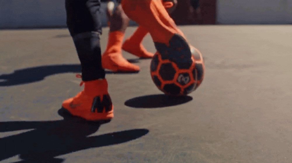 a close up of a person kicking a soccer ball