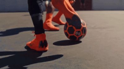 a close up of a person kicking a soccer ball