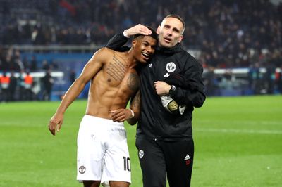 a couple of men standing on top of a soccer field