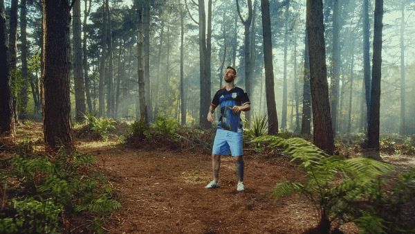 a man standing in the middle of a forest