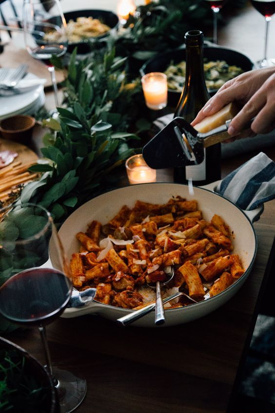 a person pouring wine into a bowl of food