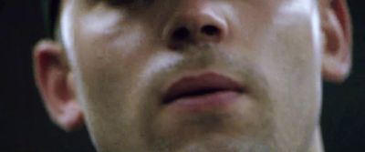 a close up of a man's face with a blurry background