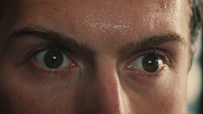 a close up of a man's face with brown eyes