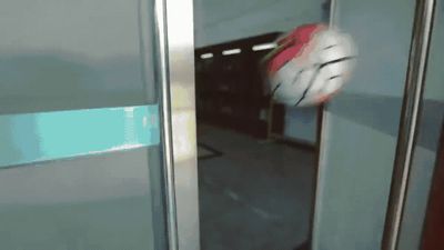 a red and white ball is in the middle of a door