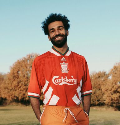 a man with a beard standing in a field