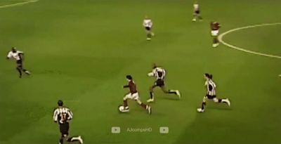 a group of men on a field playing soccer