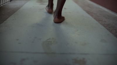 a close up of a person walking down a sidewalk