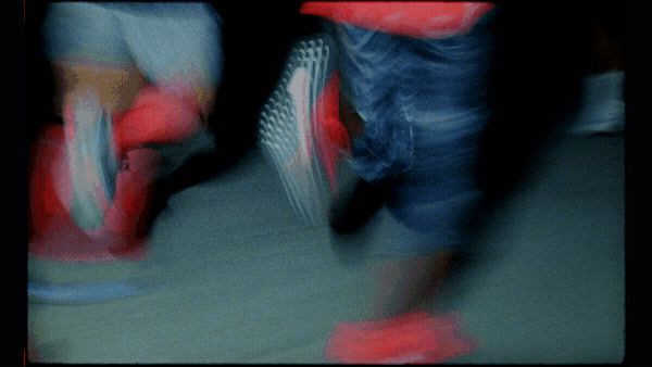 a blurry photo of a person's feet and shoes