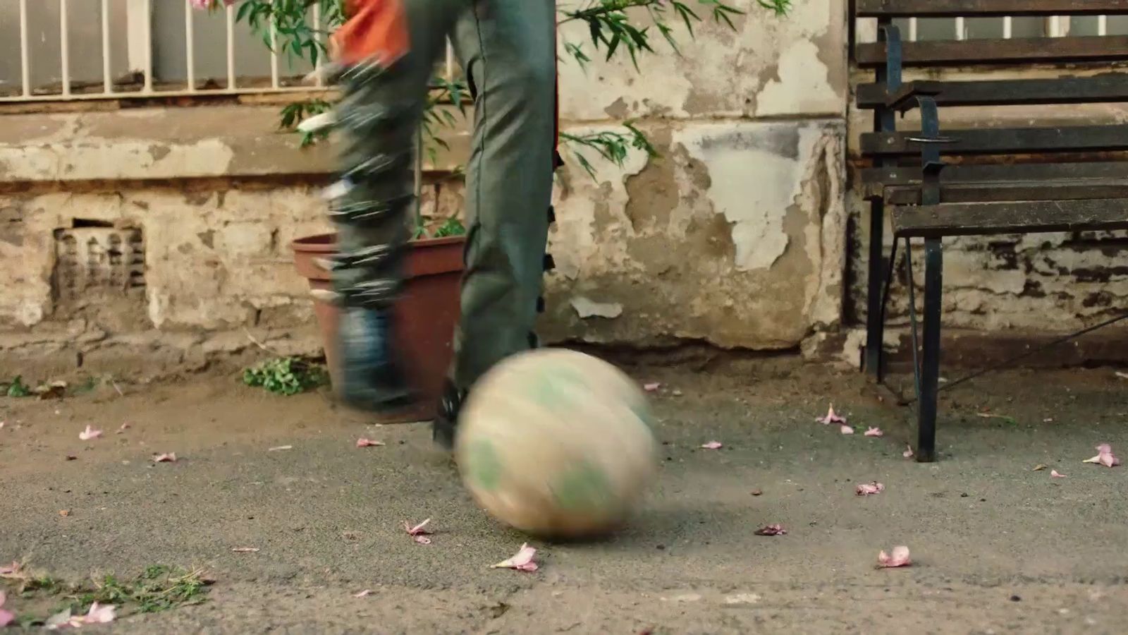 a person kicking a soccer ball on the ground