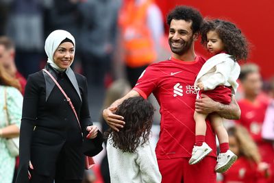 a man and a woman holding a child in their arms