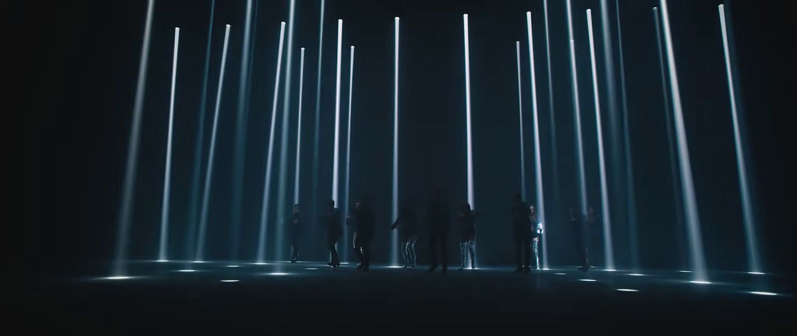 a group of people standing in front of a stage