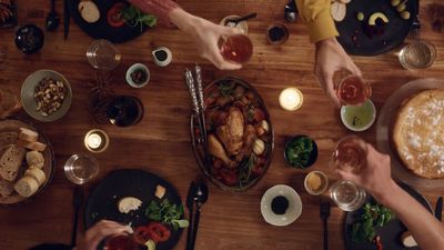 a group of people sitting at a table with food