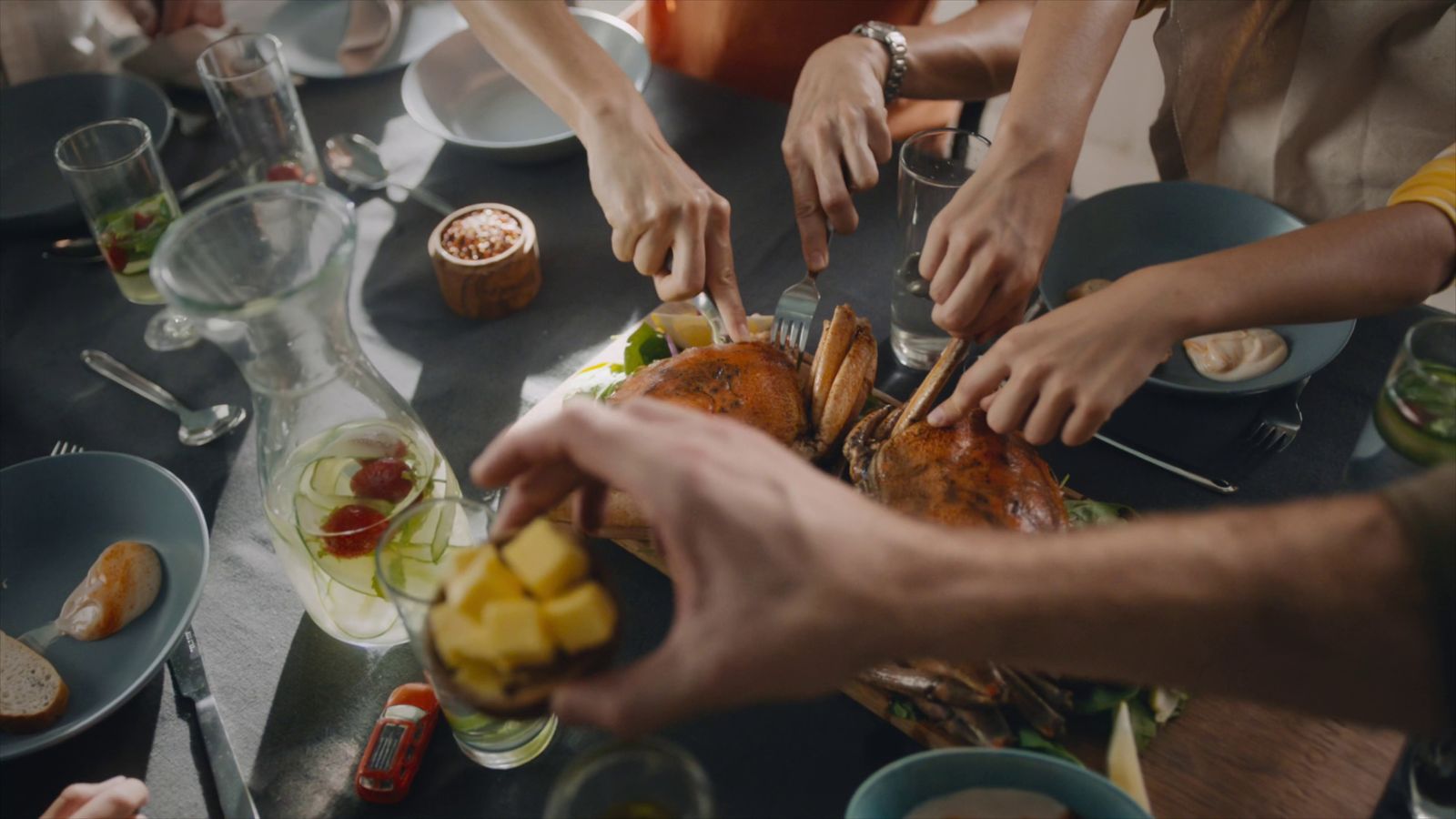 a group of people sitting around a table eating food