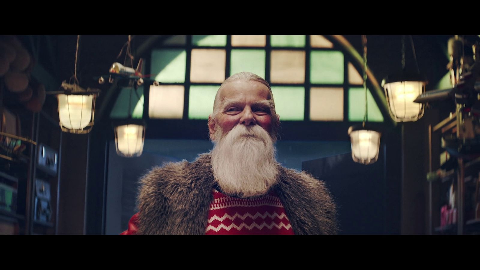 a man with a long white beard wearing a red sweater