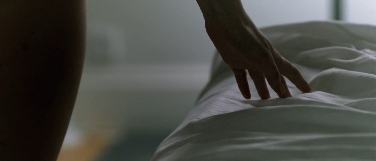 a person reaching for something on a bed