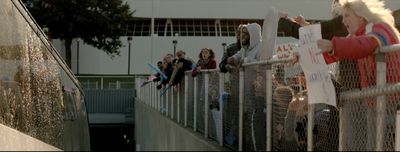 a group of people standing next to each other near a fence