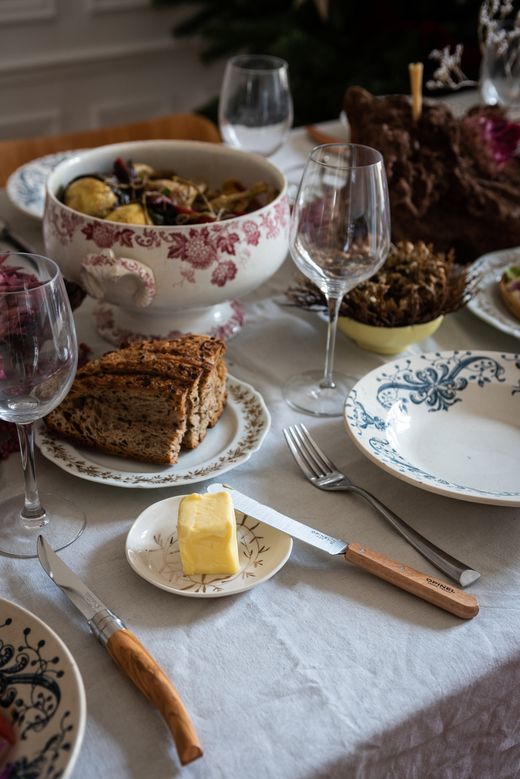 a table topped with plates and bowls filled with food