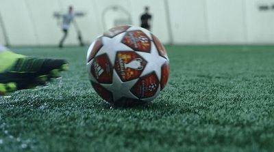 a soccer ball sitting on top of a green field